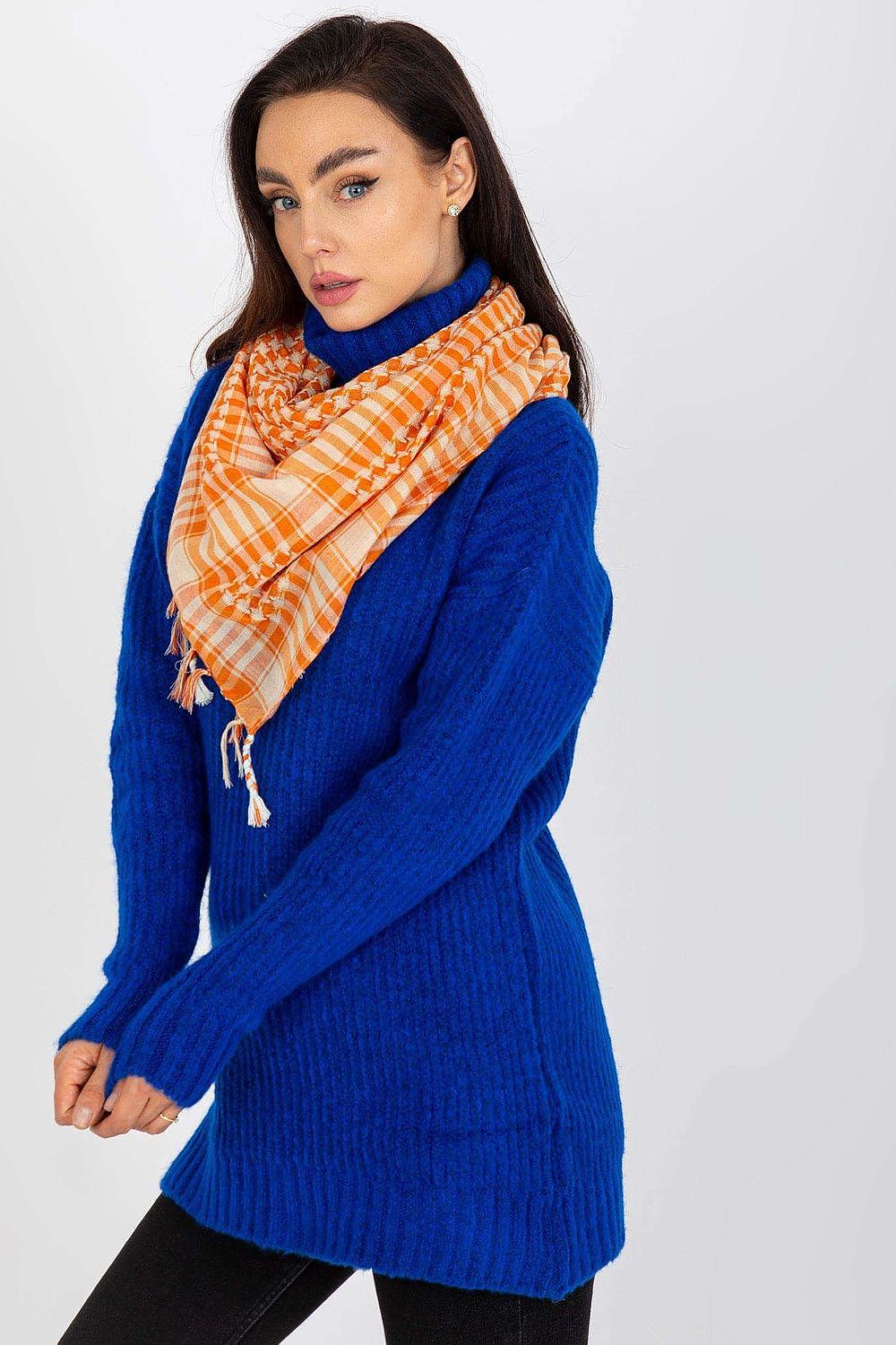 Elegant model showcasing an orange and cream checkered neckerchief scarf, paired with a blue knit sweater, exuding sophistication and modern fashion.