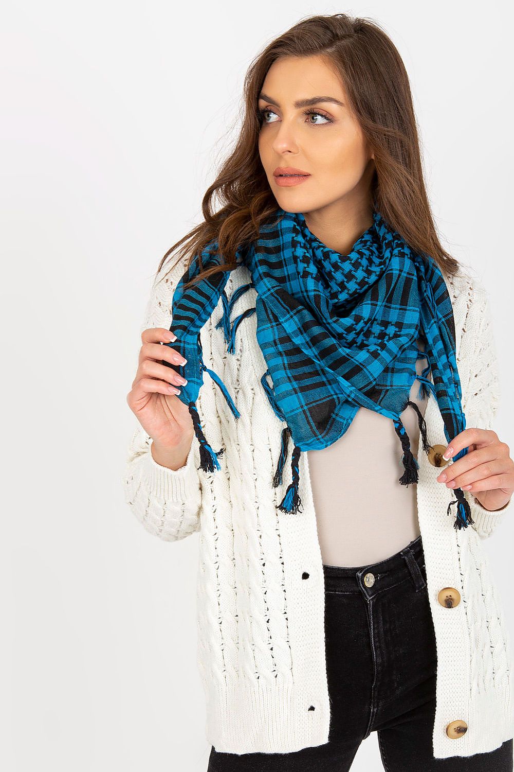 Chic luxury scarf in deep blue checkered design, complemented by a fashionable cream knitted cardigan worn by a model, illustrating stylish layering options.