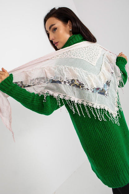 Elegant model showcasing a vintage-style 100% cotton neckerchief scarf, measuring 65 x 141 cm, perfectly draped over a vibrant green knit sweater, highlighting the scarf's intricate lace and floral details in a luxurious setting.