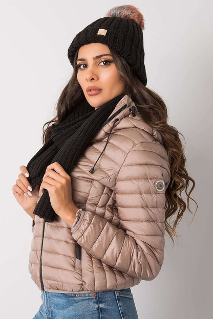 Elegant winter accessories featuring a black hat and scarf set, complemented by a stylish woman posing in a fashionable puffer coat, ideal for the colder season.