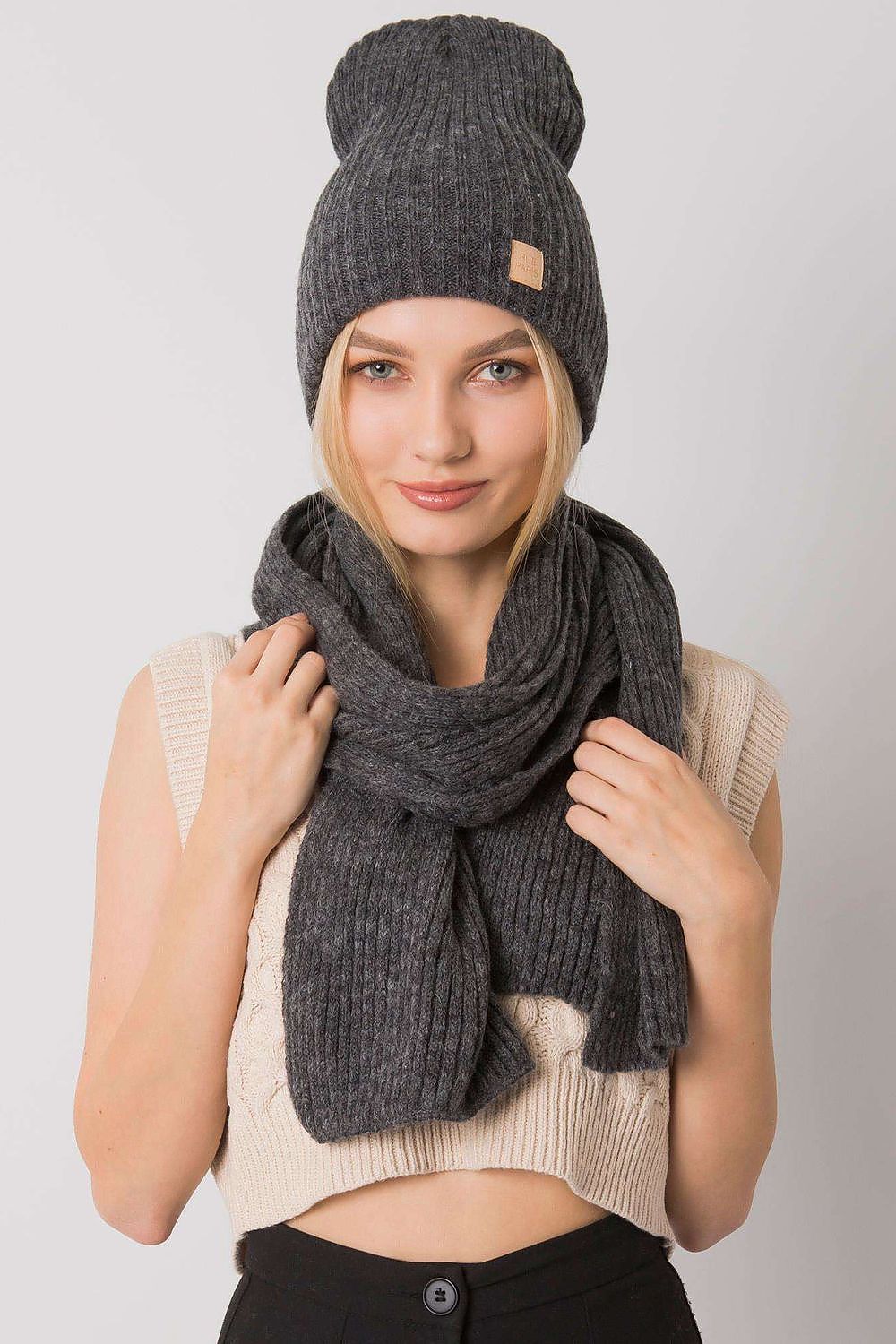 Sophisticated grey acrylic winter hat and scarf set, modelled with a chic knitted crop top, perfect for a stylish winter ensemble.