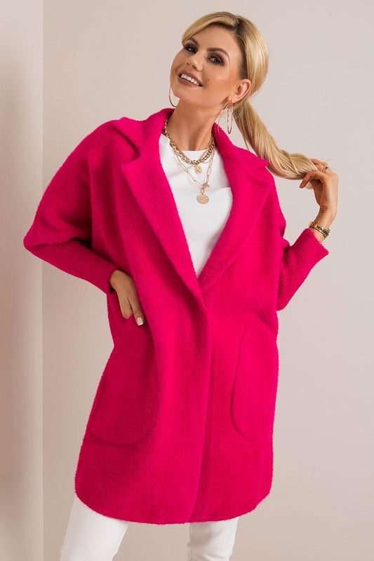 Chic luxury women's wool blend coat in vibrant pink, featuring angora, press stud fastening, and slip pockets, styled elegantly with layered accessories.