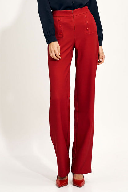 Chic high-rise wide-leg trousers in a bold red hue by Nife, adorned with fashionable button details, styled with a coordinating blouse, perfect for upscale occasions.