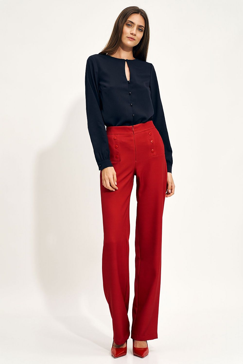 Sophisticated ensemble featuring high-rise wide-leg red trousers by Nife with button accents, complemented by an elegant navy blouse, exuding luxury fashion.