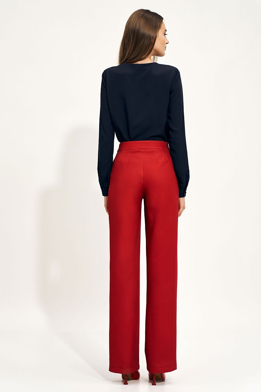 Sophisticated high-rise wide leg trousers in vibrant red worn by a model, showcasing a sleek back view, complemented by a tailored blouse, perfect for both formal and casual occasions.