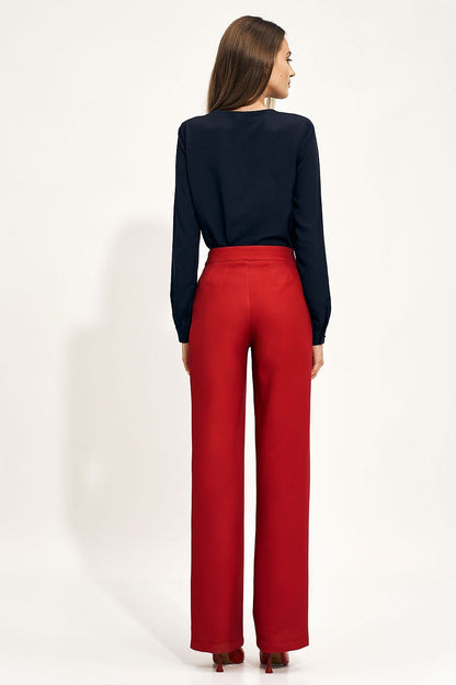Sophisticated high-rise wide leg trousers in vibrant red worn by a model, showcasing a sleek back view, complemented by a tailored blouse, perfect for both formal and casual occasions.