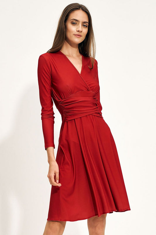 Elegant red midi dress with envelope neckline and creased waist, perfect for autumn fashion, styled on a model.