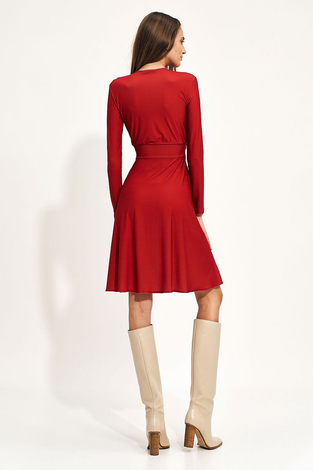 Back view of a luxurious red midi dress featuring an envelope neckline and creased waist, styled with elegant knee-high boots.