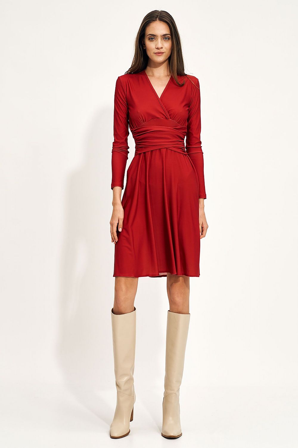 Elegant red midi dress with an envelope neckline, featuring a creased waist, styled with chic beige knee-high boots, ideal for autumn fashion.