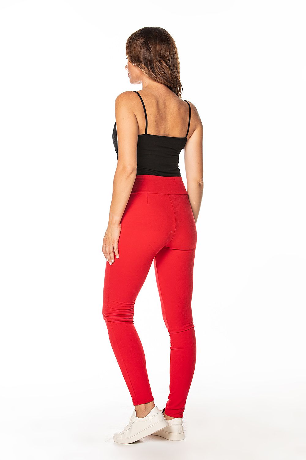 Chic back view of a woman wearing luxurious cotton knit tracksuit trousers in striking red by Tessita, highlighting the sophisticated design and perfect fit.