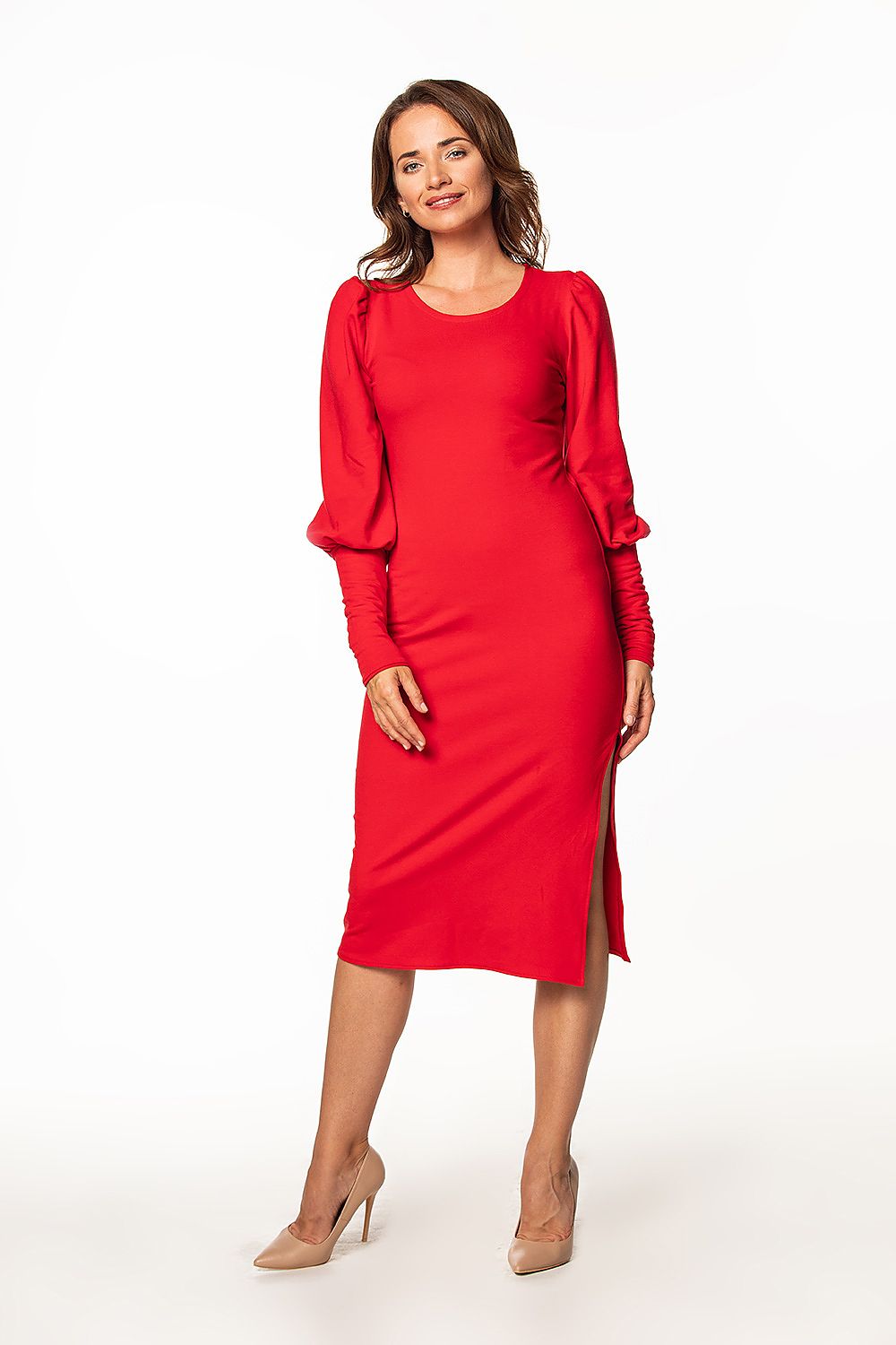 Sophisticated red knitted midi dress by Tessita featuring a boat neckline and long buff sleeves, perfectly complementing the model's graceful pose.
