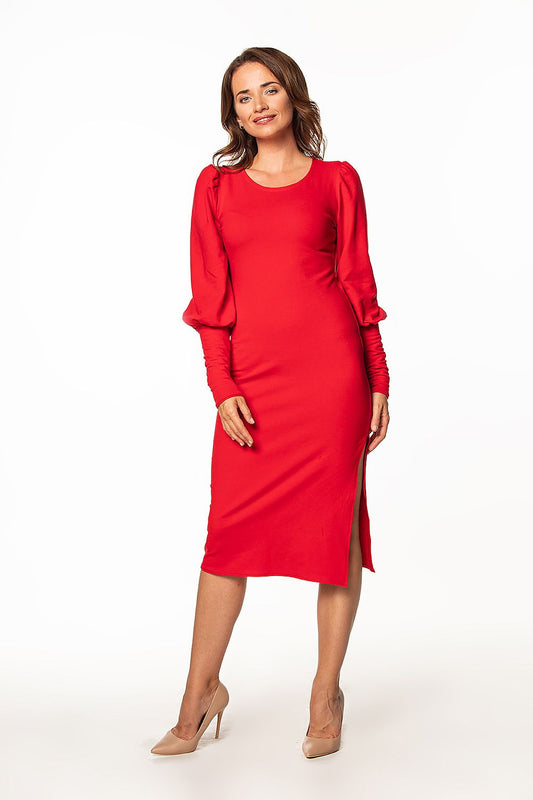 Sophisticated red knitted midi dress by Tessita featuring a boat neckline and long buff sleeves, perfectly complementing the model's graceful pose.
