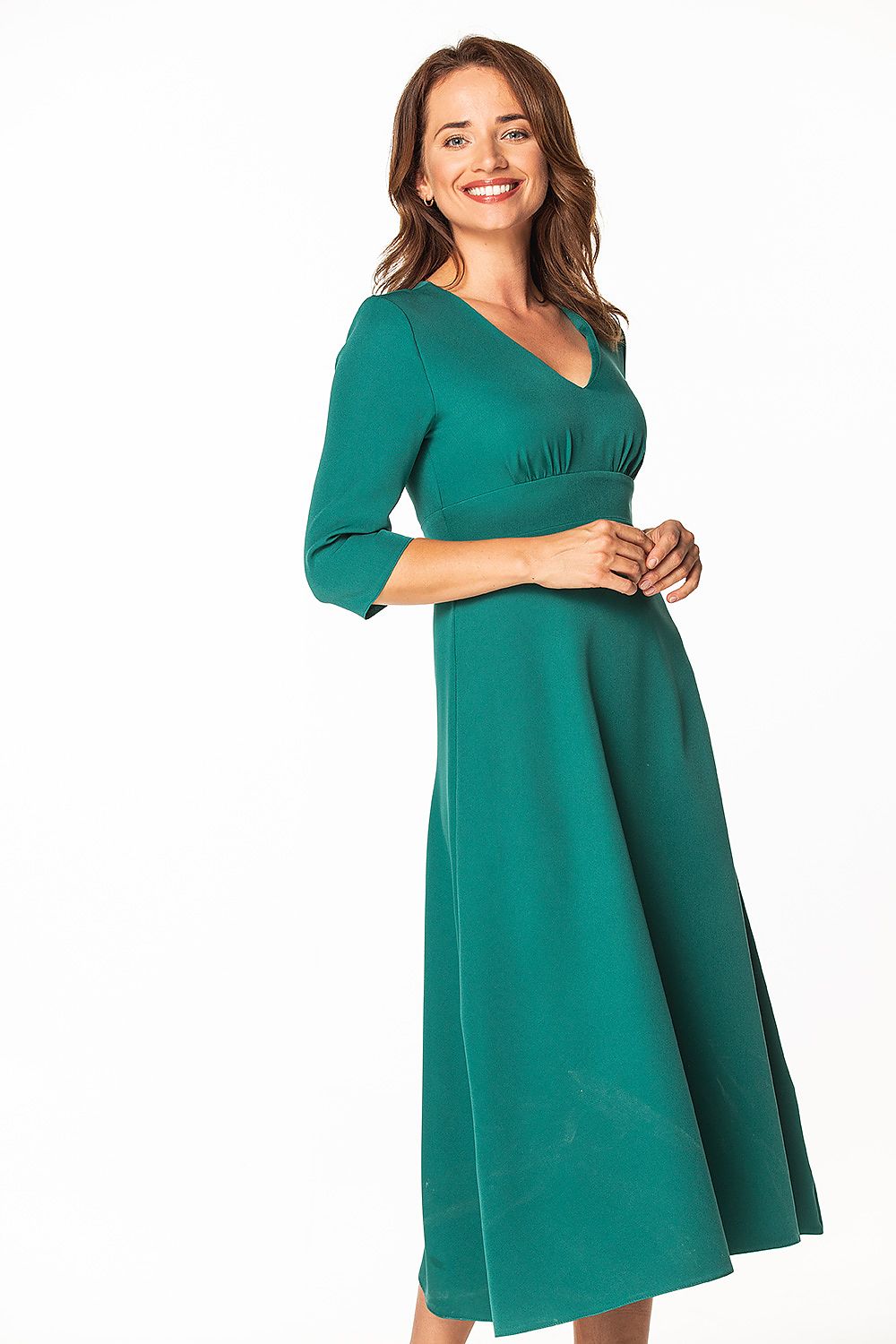 A stunning woman showcasing the elegant Tessita Maxi Dress in a vibrant green hue, featuring 3/4 sleeves and a tasteful covered zipper, ideal for various occasions.