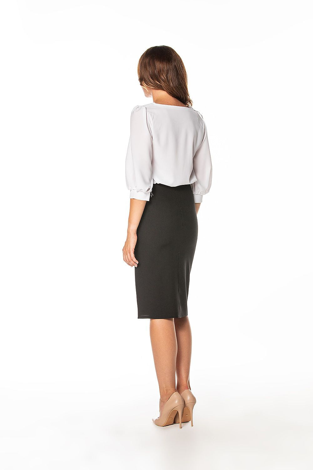 Stylish Tessita pencil midi skirt worn by a model, highlighting its flattering fit and trendy side slit design.