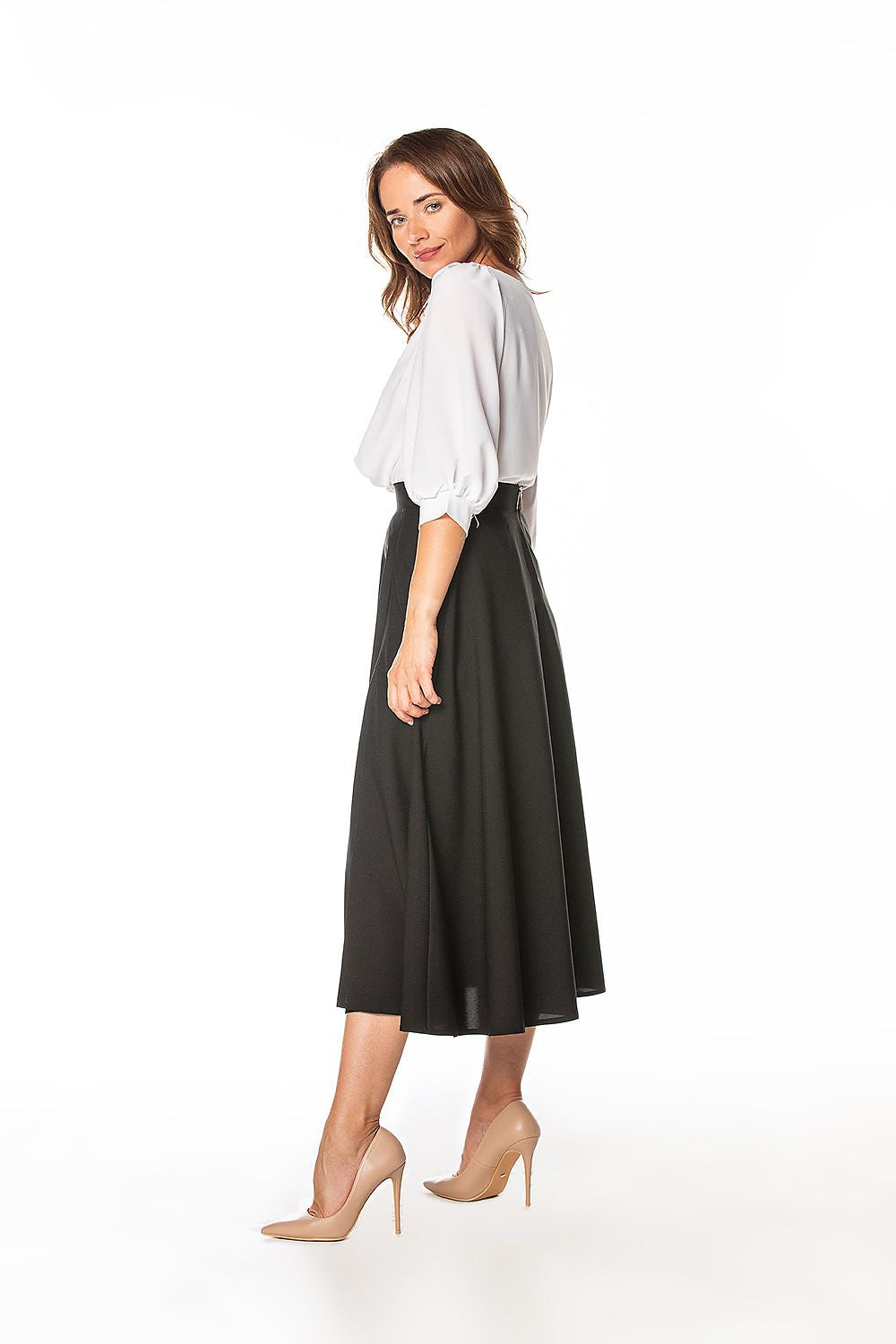 Model wearing the Tessita mid-calf skirt with left slit, demonstrating its flexible fit and stylish silhouette for an upscale wardrobe.