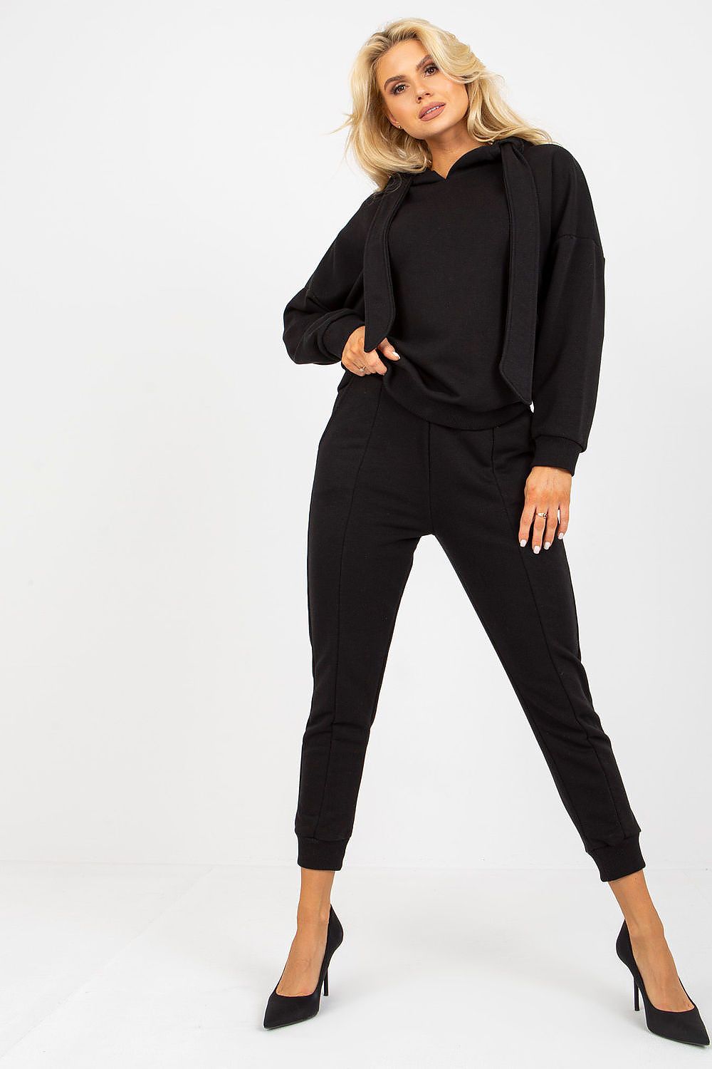 Elegant model showcasing a luxury black cotton hoodie sweatshirt and wide elastic band sweatpants set, exuding a chic and sophisticated look. Perfect for stylish casual wear.