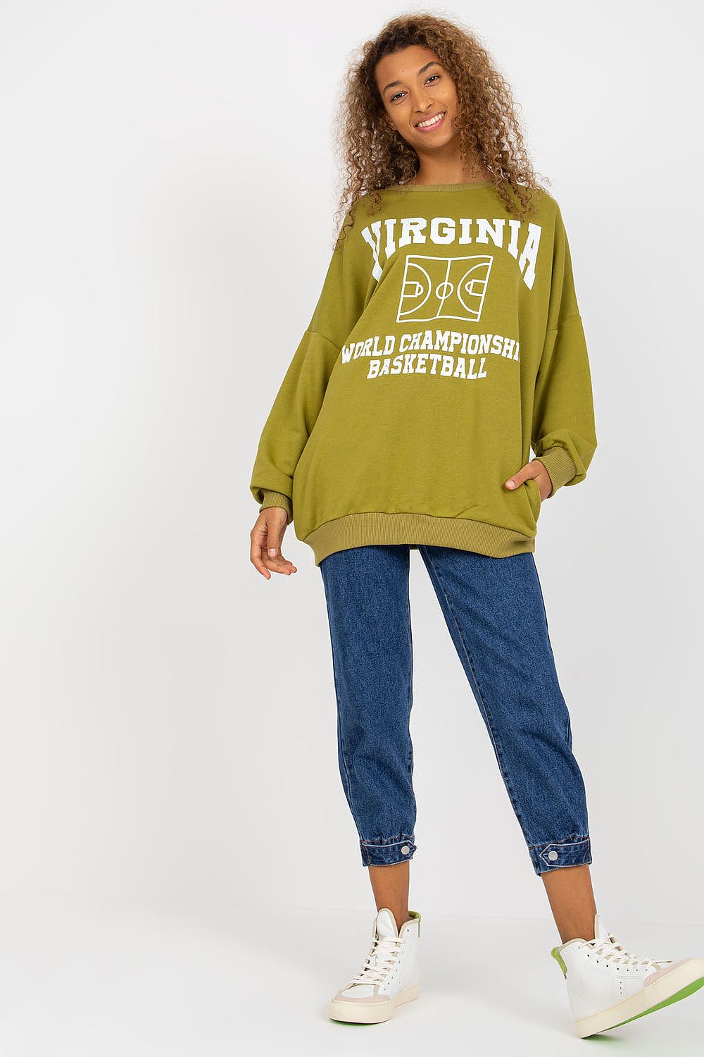 Chic olive green sweatshirt embellished with a basketball design, paired with tailored denim and modern sneakers for an effortless luxury outfit.