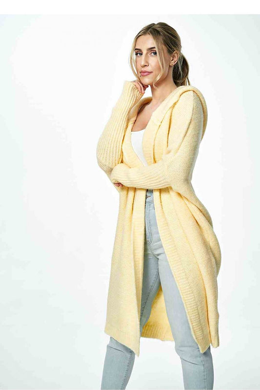 Elegant yellow Figl cardigan styled with a white top and grey jeans, exuding luxury and comfort.