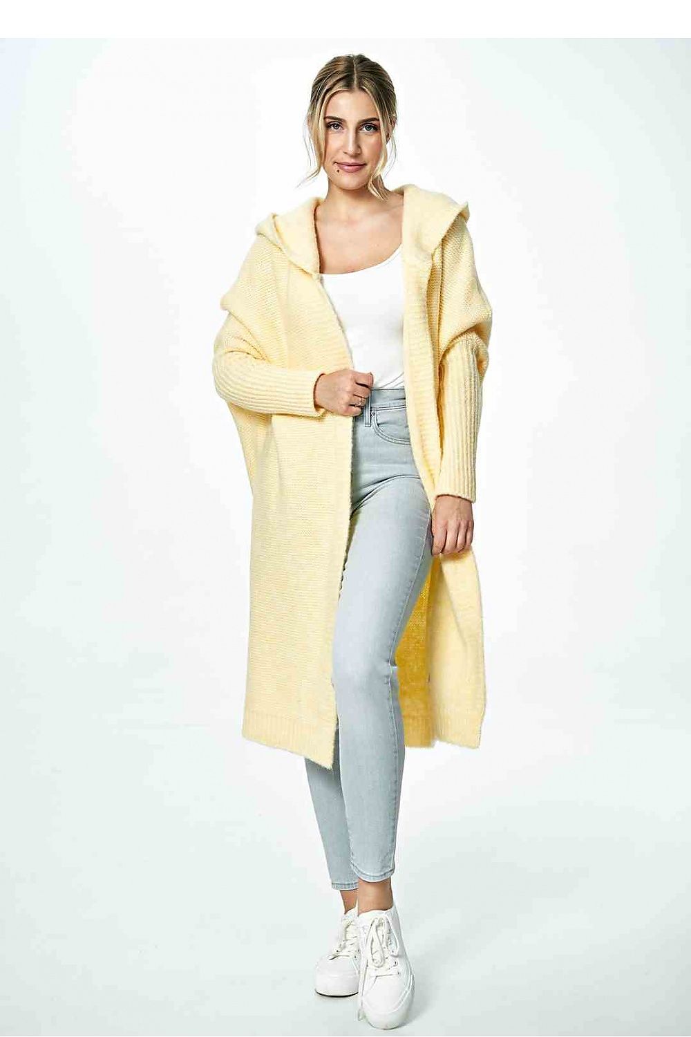 Chic yellow Figl cardigan gracefully open, paired with a white top and grey skinny jeans, perfect for a stylish casual look.
