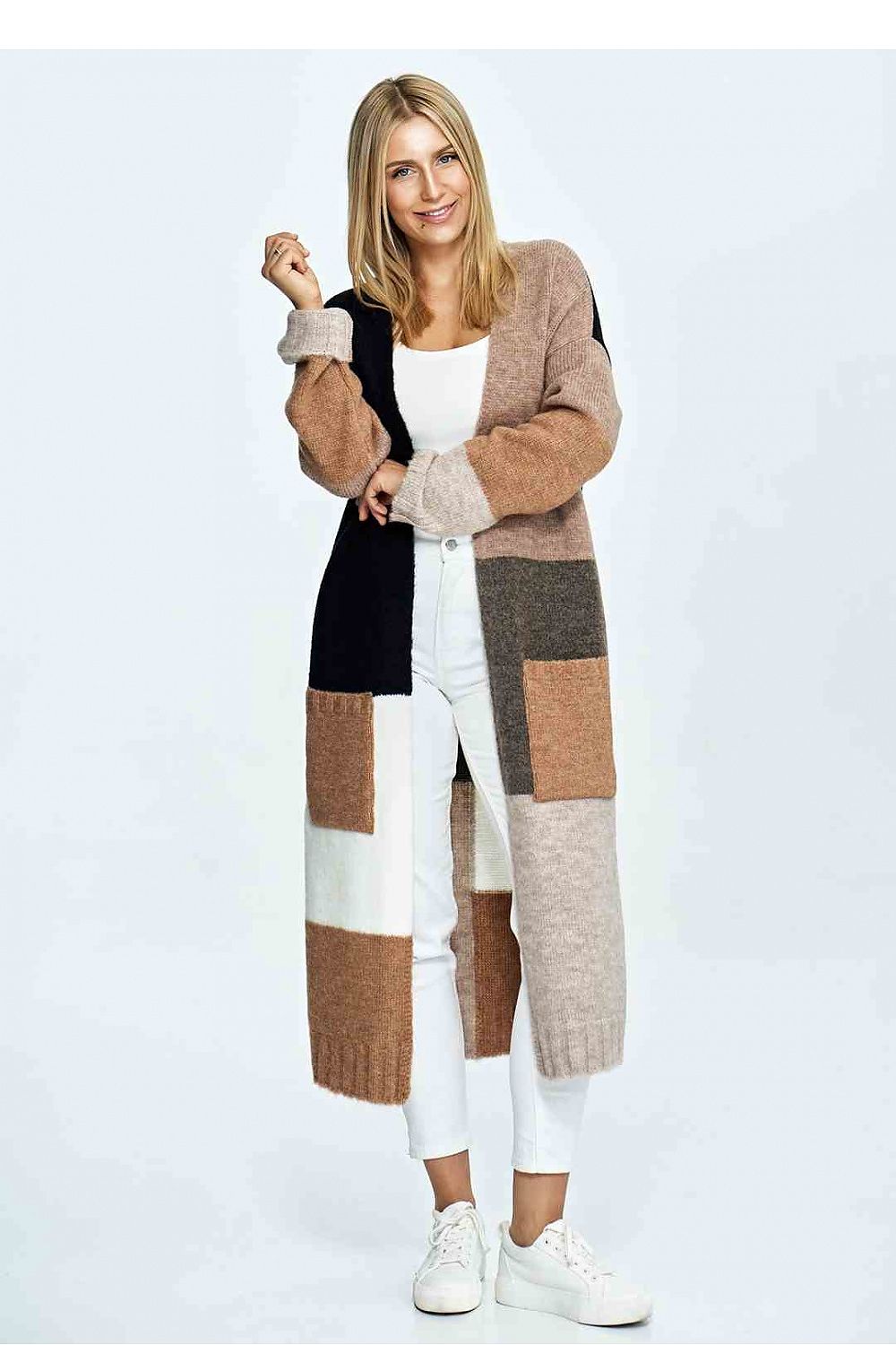 Chic model posing in a luxury patchwork Figl cardigan with earthy tones, accentuated by white trousers, embodying sophisticated casual wear.