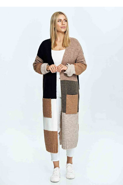 Sophisticated woman wearing a luxury two-tone Figl cardigan with a stylish patchwork design, paired with white trousers, perfect for a chic ensemble.