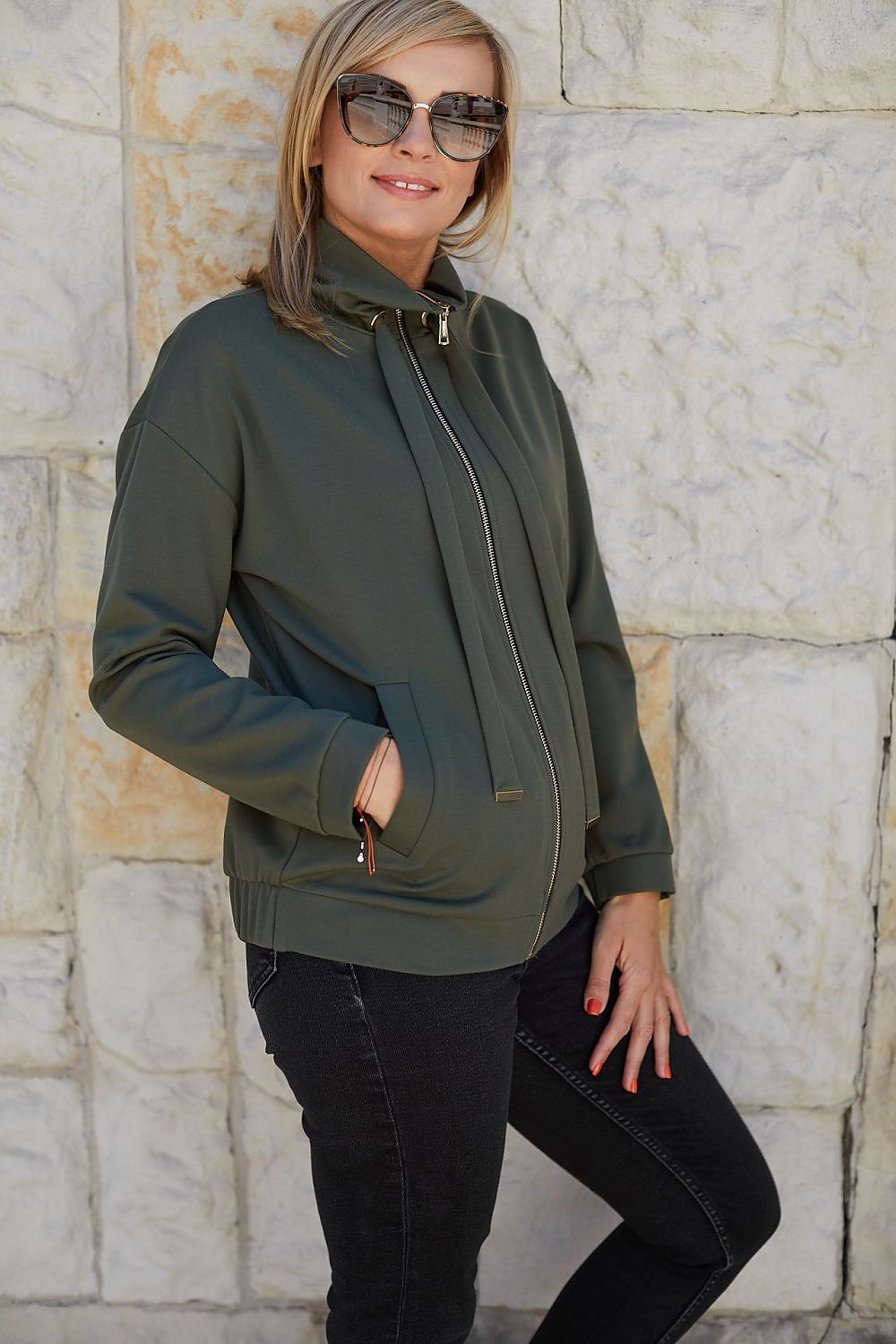 Chic model showcasing the La Aurora Luxury Unbuttoned Sweatshirt, highlighted by its sleek design and elegant details, captured in a stylish urban setting.