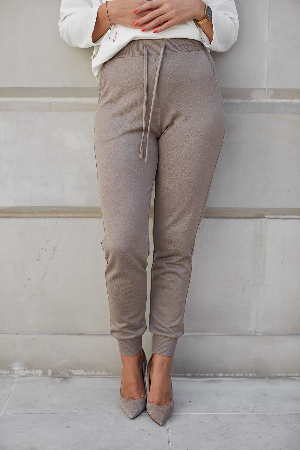 Elegant women's viscose stretch trousers, featuring a fitted design and drawstring waist, showcased in a stylish and sophisticated manner against a modern backdrop.