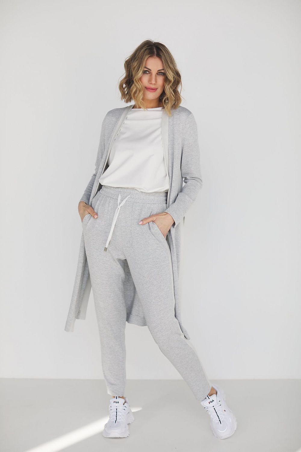 Elegant grey viscose loungewear set featuring high waist pants and a loose blouse, perfectly styled for comfort and sophistication. Model showcasing the versatile outfit suitable for casual outings or relaxed gatherings.