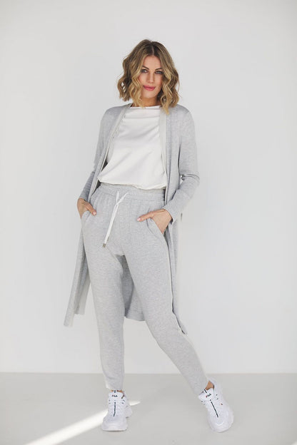 Elegant grey viscose loungewear set featuring high waist pants and a loose blouse, perfectly styled for comfort and sophistication. Model showcasing the versatile outfit suitable for casual outings or relaxed gatherings.