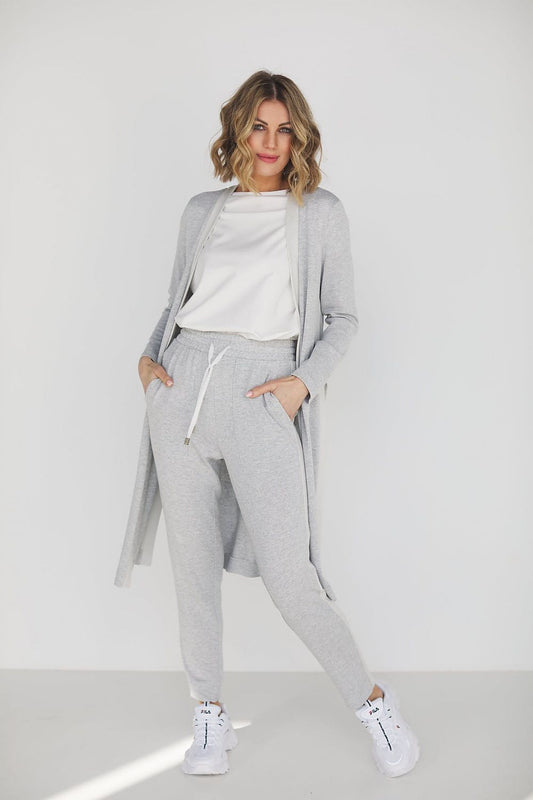 Elegant grey viscose loungewear set featuring high waist pants and a loose blouse, perfectly styled for comfort and sophistication. Model showcasing the versatile outfit suitable for casual outings or relaxed gatherings.