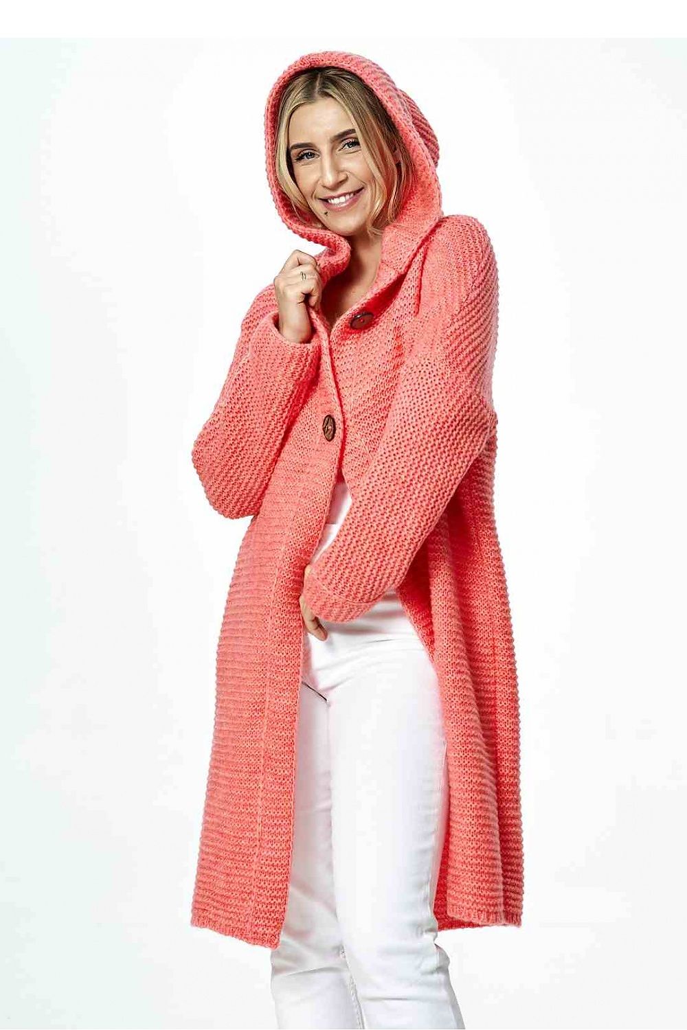 Luxurious hooded cardigan in coral with decorative buttons, paired with white jeans, exuding sophistication and contemporary elegance.