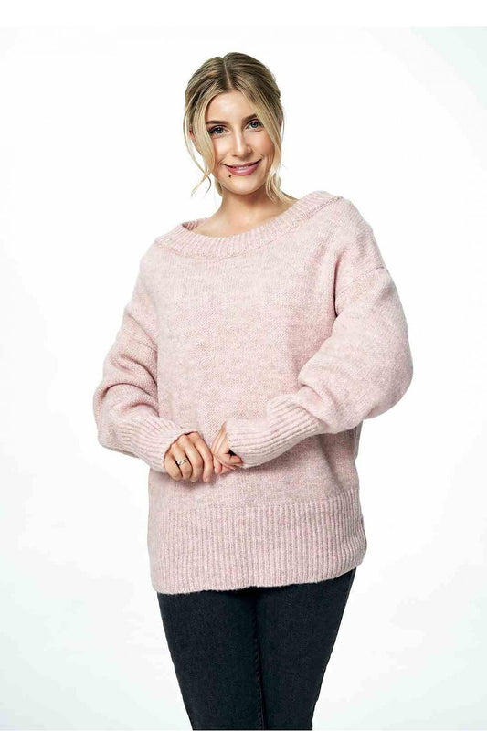 Chic view of a fashionable model wearing a soft pink loose sweater featuring a boat neckline and ribbed cuffs, perfect for a stylish autumn outfit.