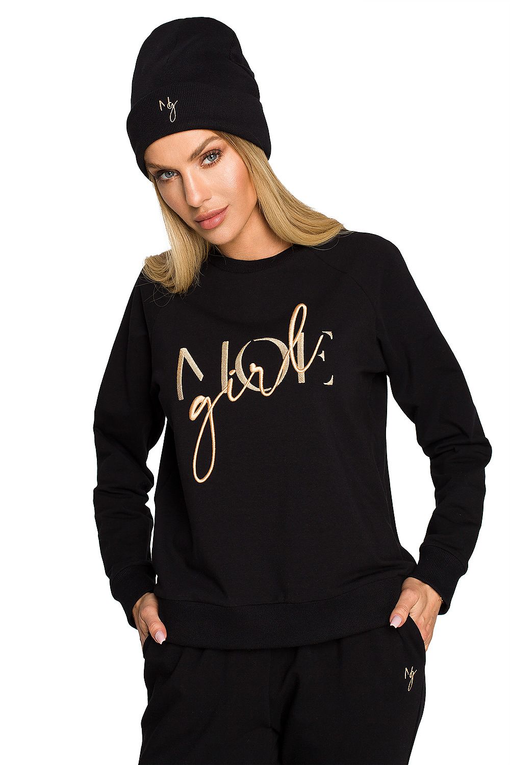 Elegantly styled model wearing a luxurious black ribbed knit cap and matching sweatshirt, showcasing delicate embroidery, perfect for chic autumn outfits.