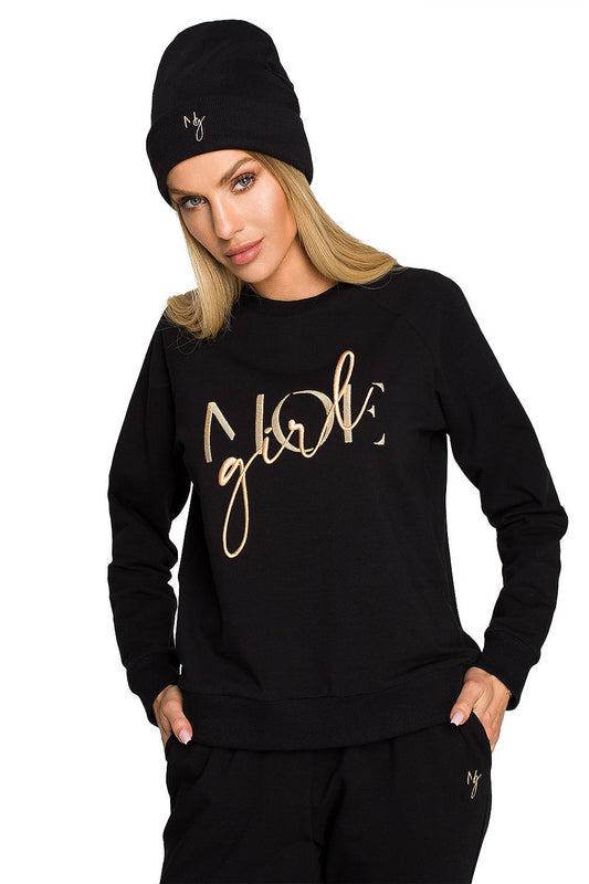 Elegantly styled model wearing a luxurious black ribbed knit cap and matching sweatshirt, showcasing delicate embroidery, perfect for chic autumn outfits.