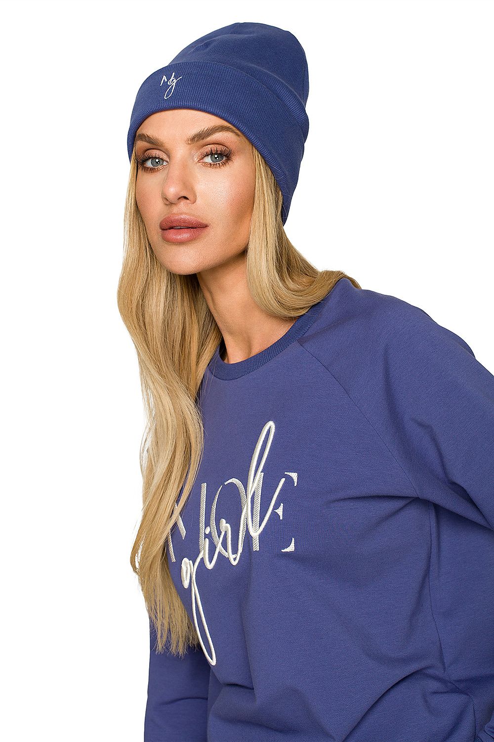 Stylish model wearing a luxurious blue ribbed knit cap with delicate embroidery, showcasing a chic autumn look paired with a matching sweatshirt.