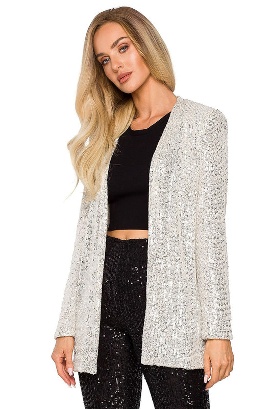 Elegant loose-fit silver sequin jacket, fully lined, styled over a black crop top, perfect for transforming any outfit into a glamorous evening look.