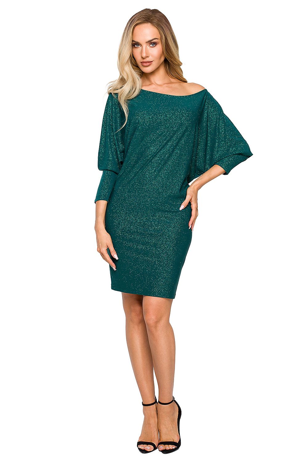 Elegant woman showcasing a luxury green evening dress by Moe, featuring a versatile brocade design and sophisticated batwing sleeves, perfect for upscale events.