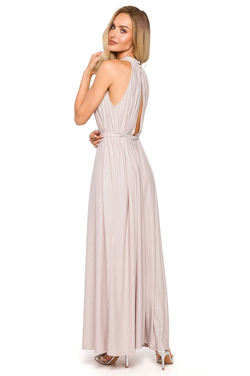 Chic back view of an elegant maxi evening dress with halter neckline and tie belt, showcasing flowing fabric design in light pink.