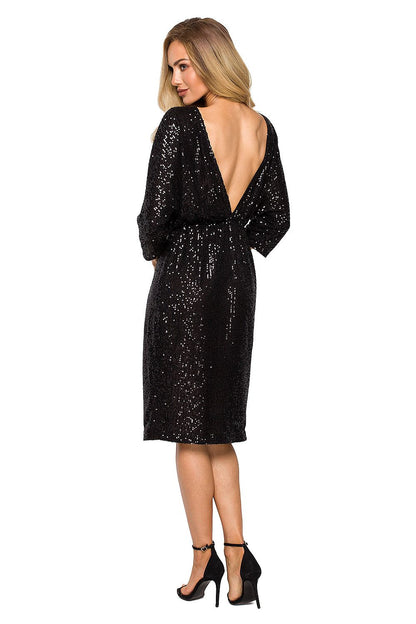 Back view of a stunning black sequin evening dress by Moe, revealing an exquisite backless design that adds allure and sophistication, model displaying a chic ensemble.