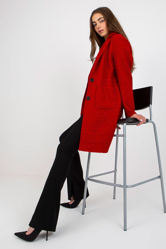 Elegant women's red luxury unlined buttoned coat by Och Bella, featuring long sleeves and patch slip pockets, styled with black flared trousers and heels against a minimalist background.