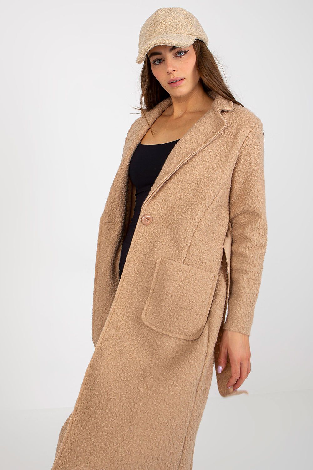 Elegant Och Bella long sleeve women's coat in soft beige, featuring a tie belt and patch pockets, styled casually with a matching cap.