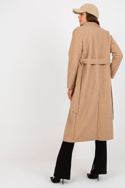 Sophisticated back view of the Och Bella women's coat in plush beige fabric, showcasing the tie belt and elegant silhouette, paired with tailored trousers.