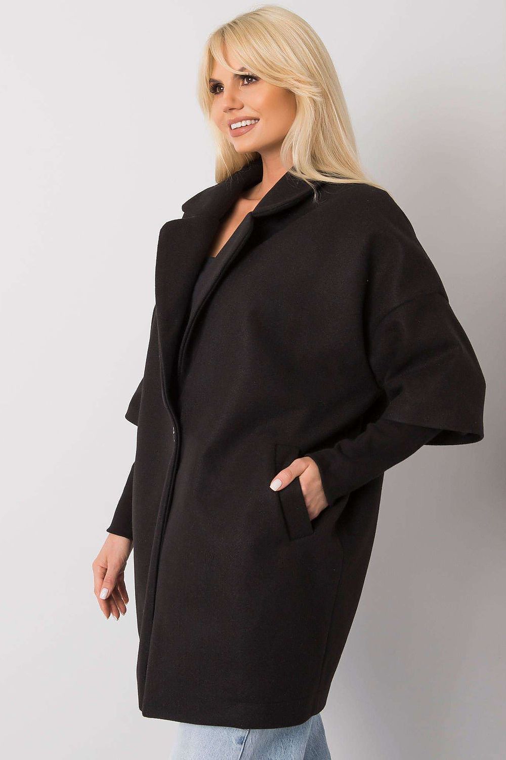Elegant black women's coat from Rue Paris featuring a loose cut, button closure, and side pockets, worn by a model with blonde hair.