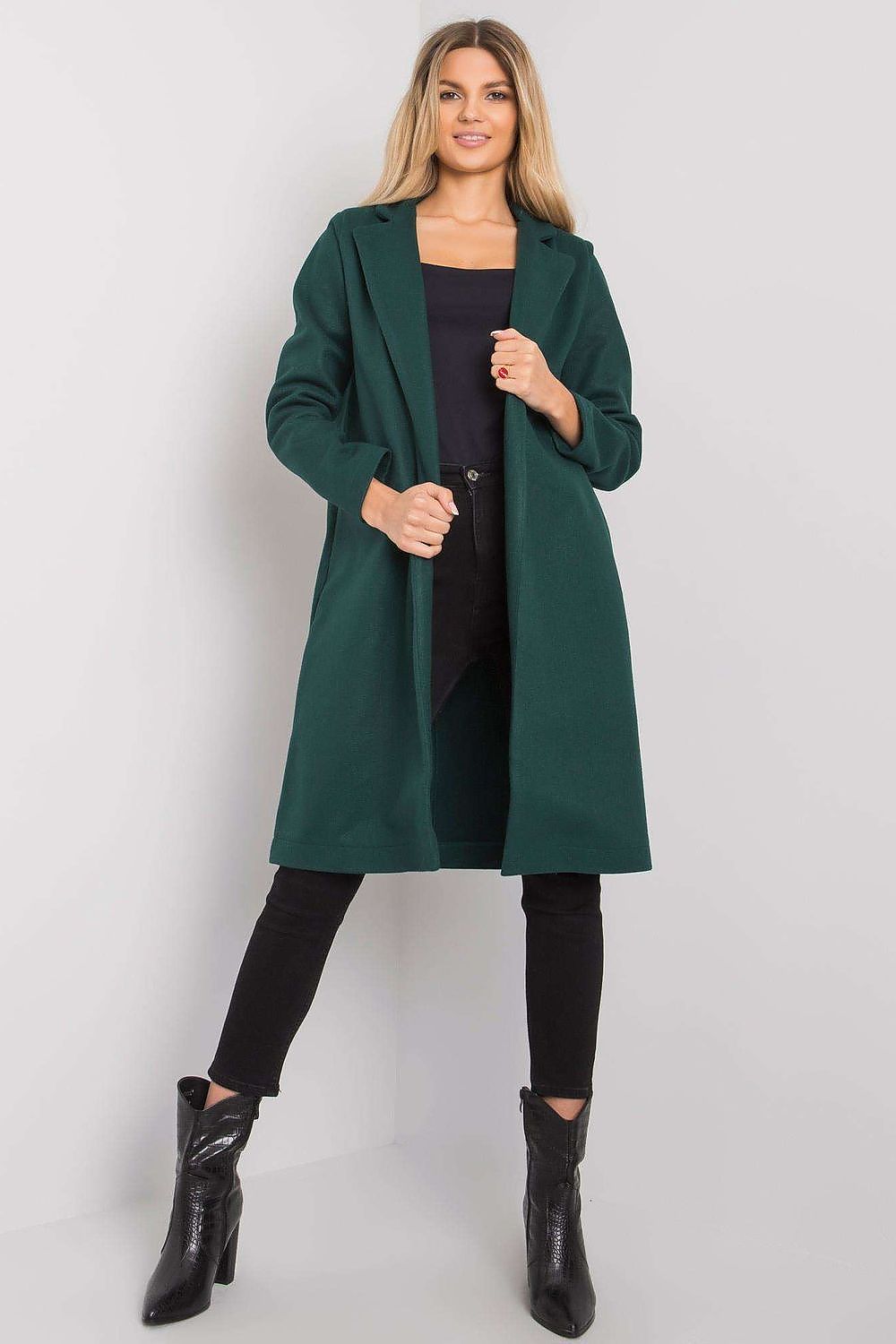 Chic feminine green coat by Rue Paris, showcasing a sophisticated design with long sleeves and on-point pocket detail, complemented by stylish black jeans.