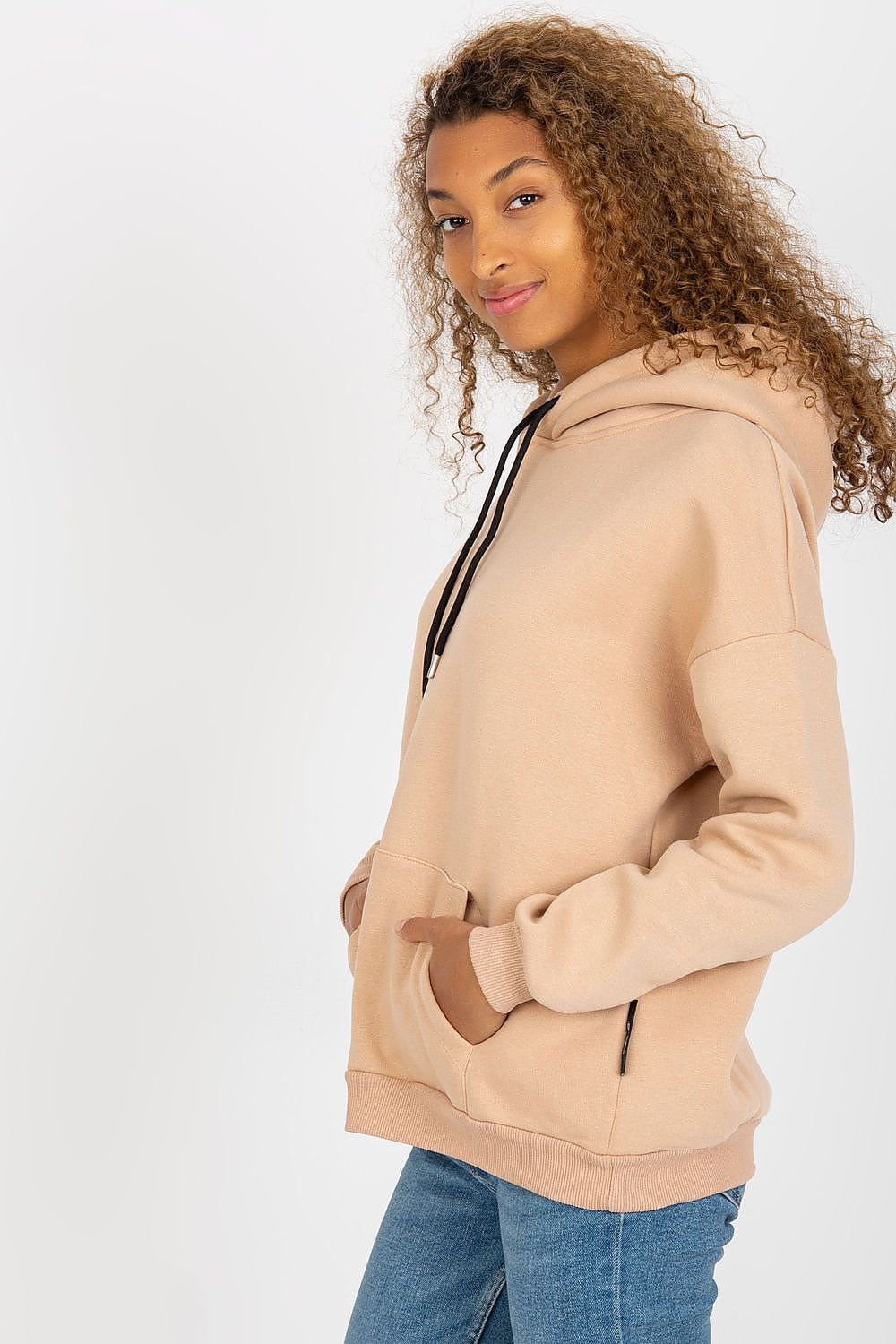 Sophisticated women's luxury hoodie sweatshirt in a soft beige shade, designed by Rue Paris, with a front kangaroo pocket and stylish side view displayed by a model.