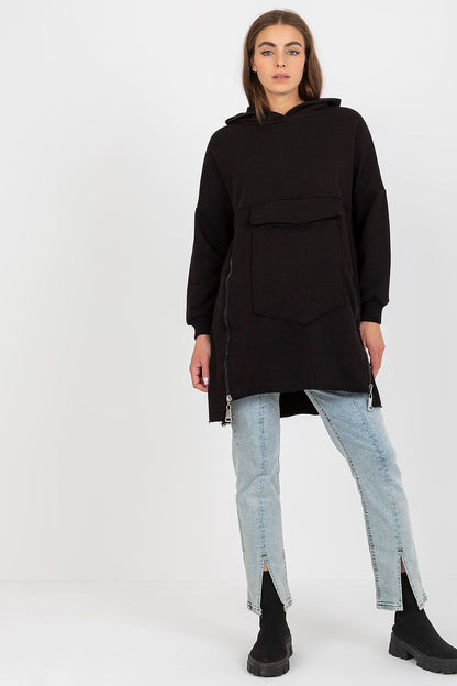 Stylish black extended cut sweatshirt featuring large pocket and zippers, complemented with light blue jeans for a trendy outfit.