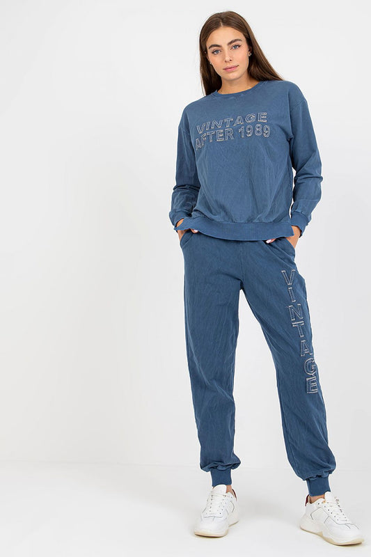 Elegant women's cotton spandex sweatshirt set showcasing a trendy loose-fit sweatshirt with long sleeves and a fashionable decorative inscription, complemented by matching long pants with an elastic waistband and side pockets, perfect for a luxurious loungewear experience.