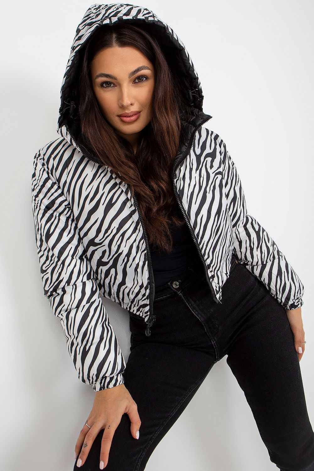 Elegant NM luxury jacket for men in a bold zebra print design, displayed by a fashionable model in a relaxed pose, highlighting its contemporary style and cozy hood.