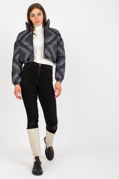 Trendy black NM polyester cropped jacket with a striking pattern, paired with high-waisted trousers and knee-length boots. A luxurious statement piece for fashionable winter outings.