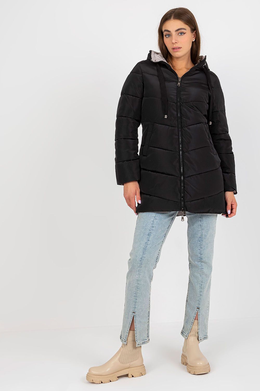 Elegant black luxury 100% polyester jacket, featuring a zip closure and hood, styled with light blue jeans and beige ankle boots, perfect for a chic winter look.